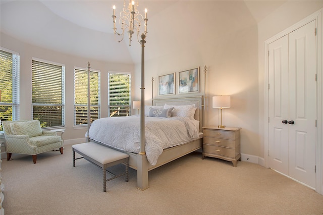 bedroom featuring light carpet, a closet, a chandelier, and baseboards