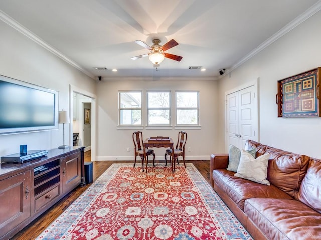 living area with dark wood-style floors, crown molding, baseboards, and a ceiling fan