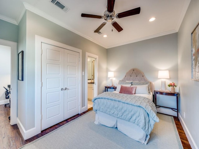 bedroom with crown molding, recessed lighting, visible vents, wood finished floors, and baseboards