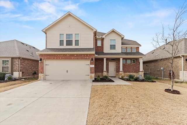 traditional home with driveway, an attached garage, a shingled roof, and brick siding