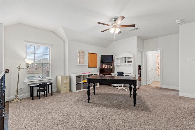 office featuring lofted ceiling, carpet flooring, visible vents, baseboards, and a ceiling fan