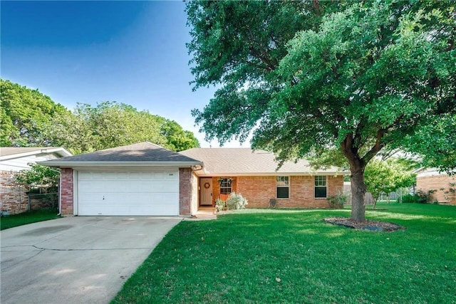 ranch-style home with a front yard, concrete driveway, brick siding, and an attached garage