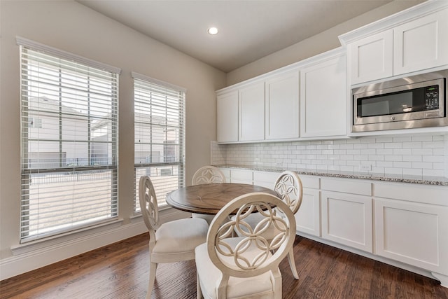 dining space with recessed lighting and dark wood-style flooring