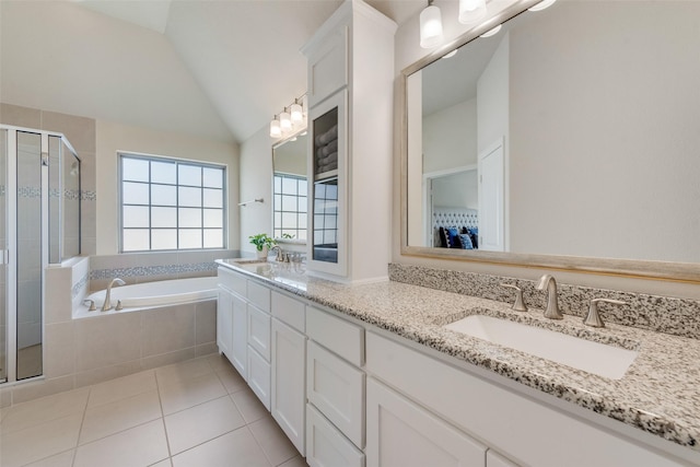 bathroom with a stall shower, vaulted ceiling, a sink, tile patterned flooring, and a bath