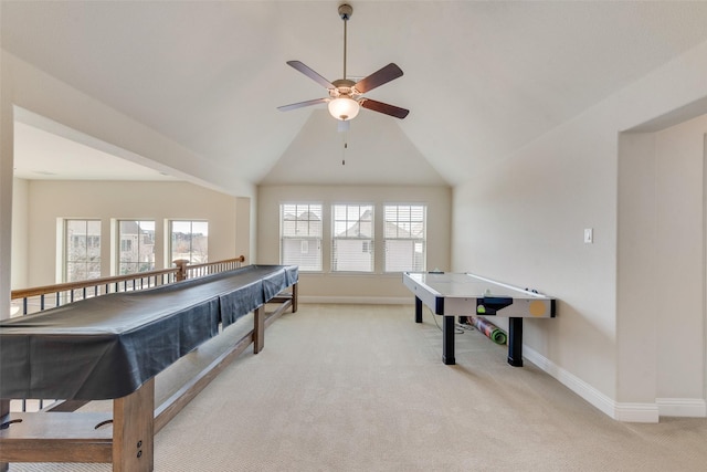 recreation room featuring baseboards, lofted ceiling, and light colored carpet