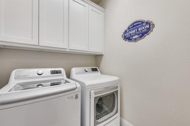 laundry room featuring cabinet space and washer and clothes dryer