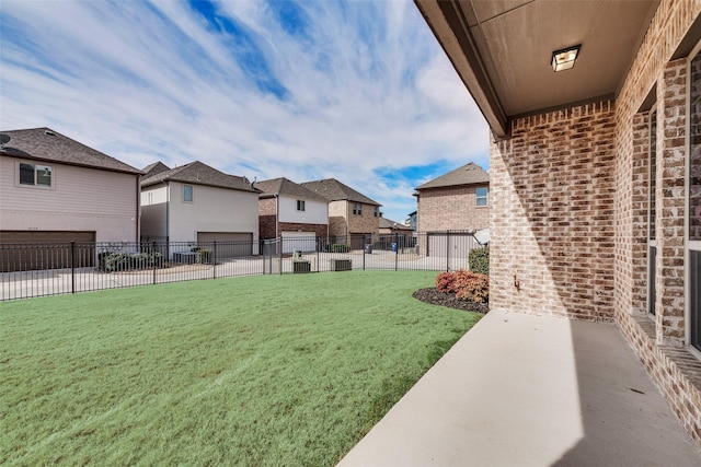 view of yard featuring fence and a residential view