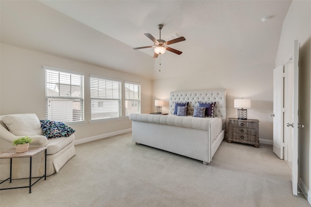 carpeted bedroom with ceiling fan, vaulted ceiling, and baseboards