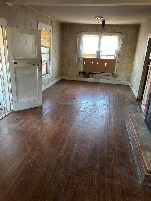 empty room featuring dark wood-style floors and plenty of natural light