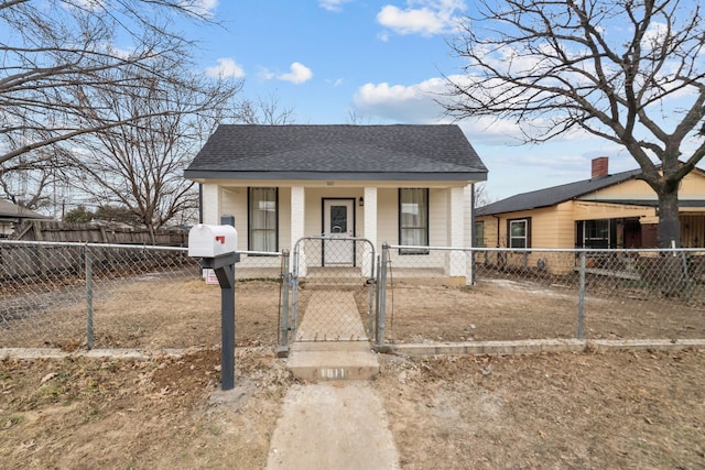 bungalow-style house with a porch, a gate, roof with shingles, and a fenced front yard