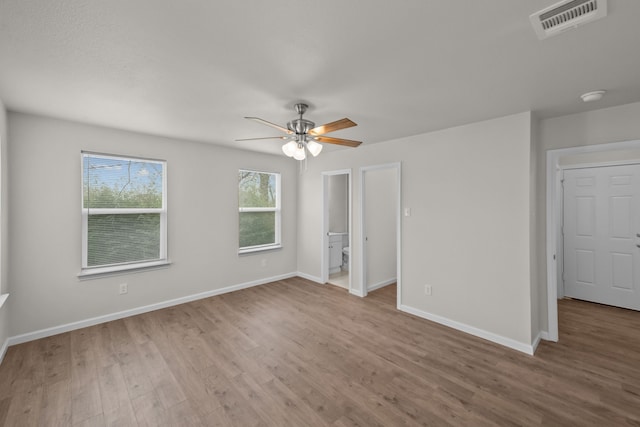 unfurnished bedroom featuring visible vents, ceiling fan, baseboards, and wood finished floors