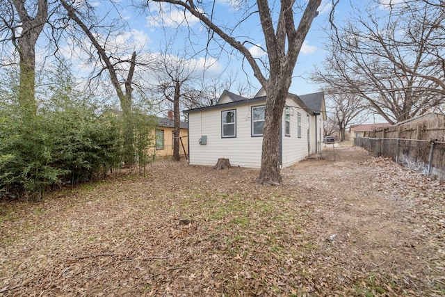 view of home's exterior with fence