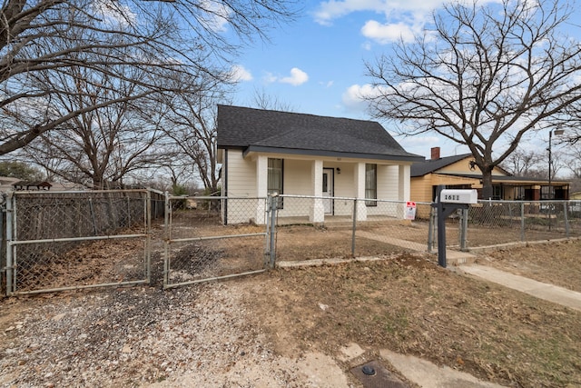 bungalow-style house featuring a fenced front yard, a gate, and roof with shingles