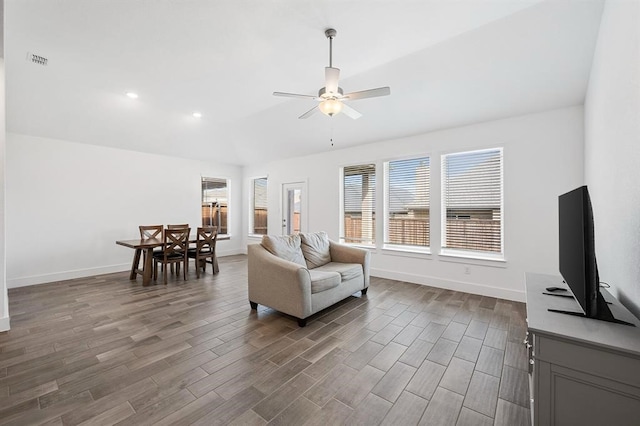 sitting room with ceiling fan, visible vents, dark wood finished floors, and baseboards