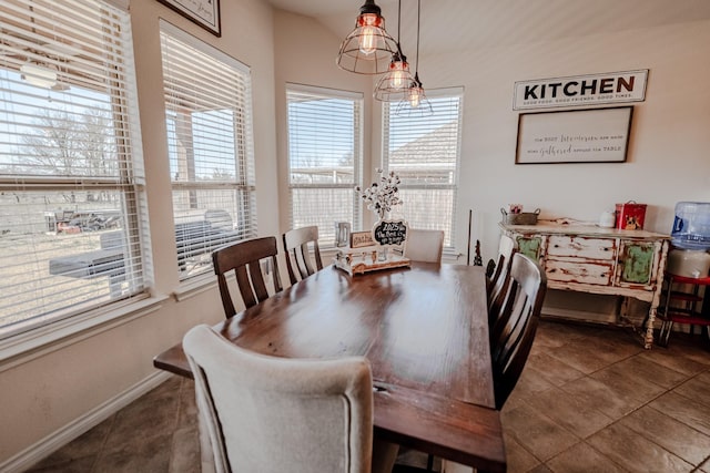 tiled dining space featuring baseboards