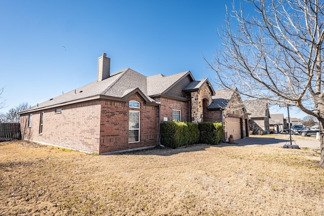 view of property exterior featuring an attached garage, brick siding, concrete driveway, stone siding, and a chimney