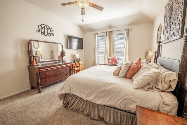 carpeted bedroom with baseboards, vaulted ceiling, and a ceiling fan