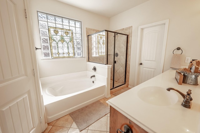 full bathroom with a shower stall, vanity, a bath, and tile patterned floors