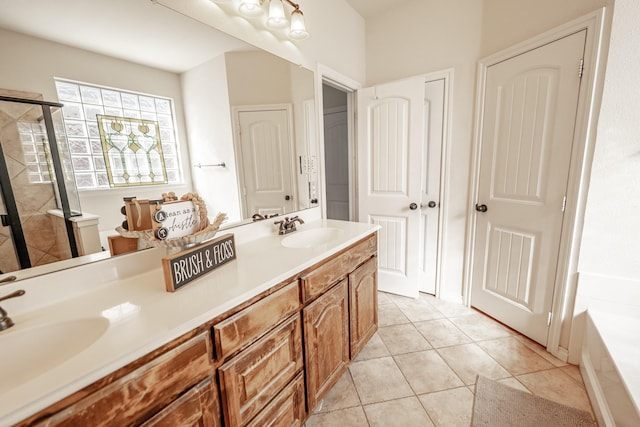 bathroom with double vanity, tile patterned flooring, a sink, and a shower stall