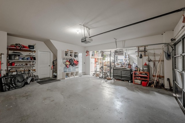 garage with a garage door opener and a workshop area