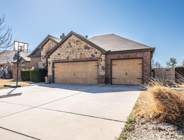 view of front facade featuring a shingled roof, concrete driveway, brick siding, and an attached garage