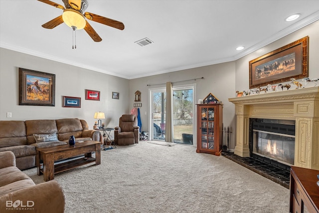 living room featuring carpet floors, visible vents, and ornamental molding