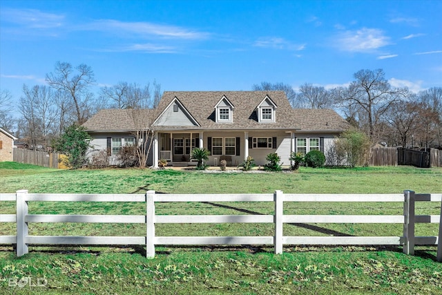 cape cod home featuring a fenced front yard and a front lawn