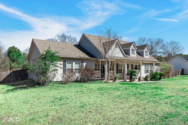 view of front of home with a front lawn and fence