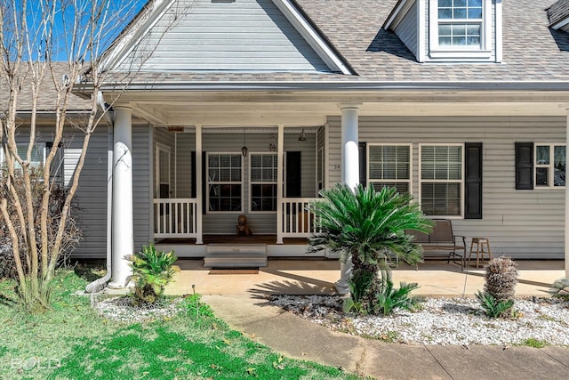 view of front facade with a porch and roof with shingles