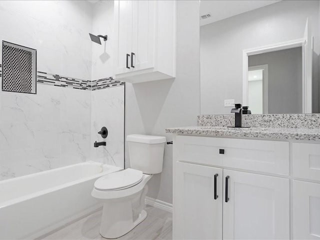full bathroom featuring visible vents, shower / bathing tub combination, toilet, vanity, and baseboards