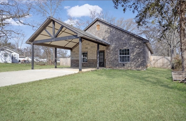 view of front of house featuring concrete driveway, brick siding, a front yard, and an attached carport