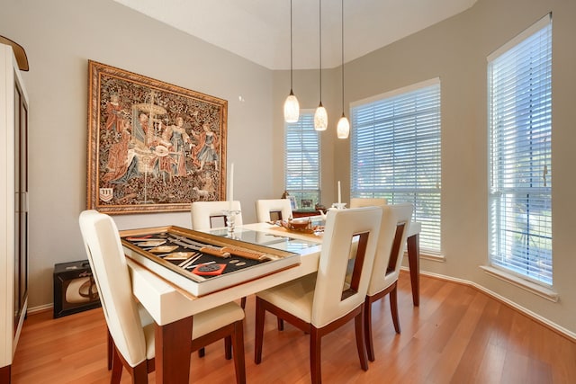 dining room featuring light wood-style flooring and baseboards