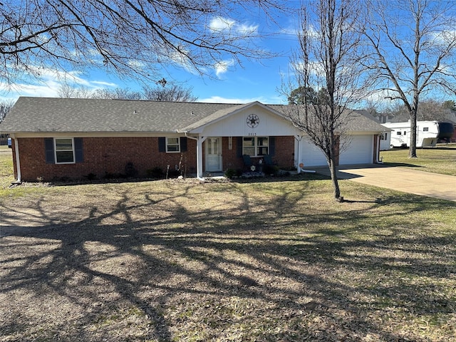 view of front of house with driveway, a garage, and brick siding