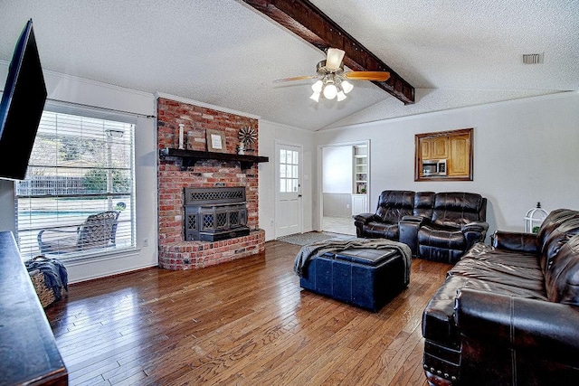 living area featuring visible vents, vaulted ceiling with beams, a textured ceiling, and light wood finished floors