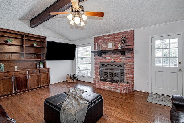 living room with ornamental molding, wood finished floors, vaulted ceiling with beams, a textured ceiling, and a brick fireplace