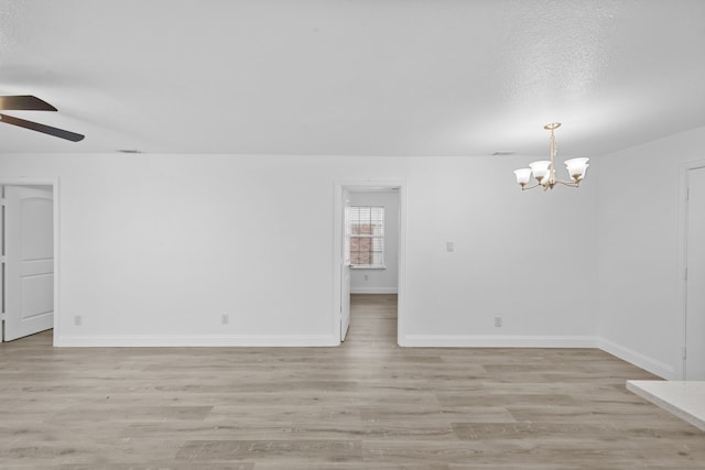 819 Netherland Dr, Arlington, TX 76017 - empty room with ceiling fan, a chandelier, light wood-type flooring, and baseboards