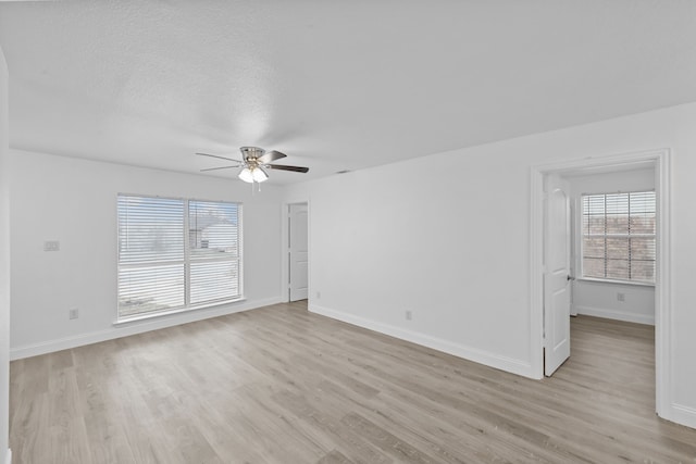 819 Netherland Dr, Arlington, TX 76017 - empty room featuring a ceiling fan, light wood-style flooring, baseboards, and a textured ceiling