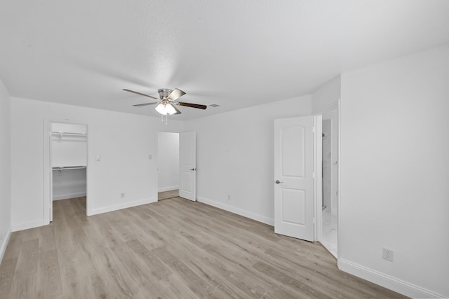 819 Netherland Dr, Arlington, TX 76017 - unfurnished bedroom featuring light wood-style flooring, baseboards, a spacious closet, and a ceiling fan
