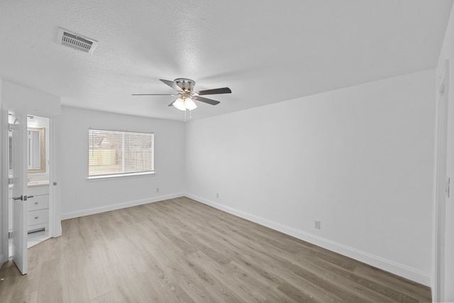 819 Netherland Dr, Arlington, TX 76017 - unfurnished bedroom featuring light wood-style floors, baseboards, ceiling fan, and a textured ceiling