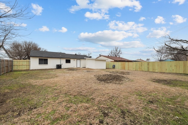 back of house featuring a fenced backyard and a yard