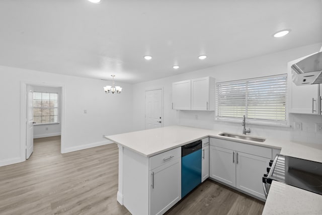 kitchen with white cabinets, dishwasher, electric stove, a peninsula, and a sink