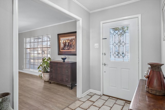 foyer entrance with light wood-type flooring, baseboards, and crown molding