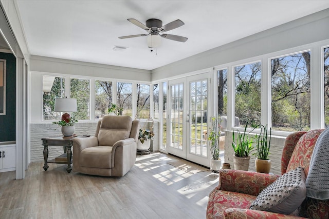 sunroom featuring french doors, visible vents, and a ceiling fan