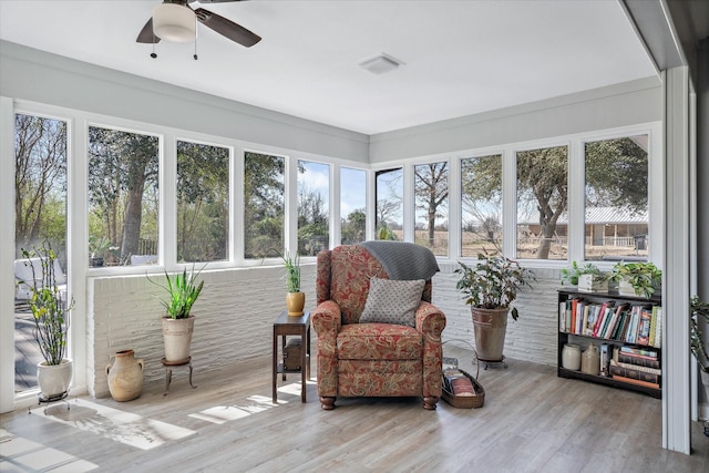 sunroom with visible vents and a ceiling fan