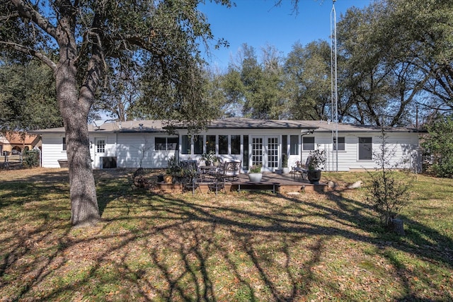 exterior space with a front yard, french doors, and a wooden deck