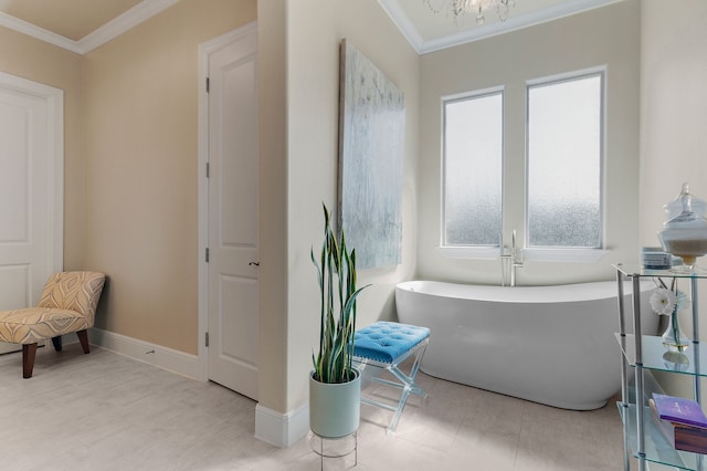 bathroom with baseboards, ornamental molding, and a freestanding bath