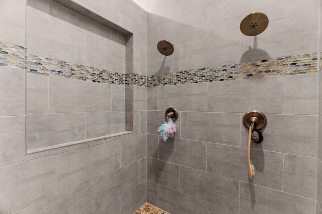 bathroom with a tile shower