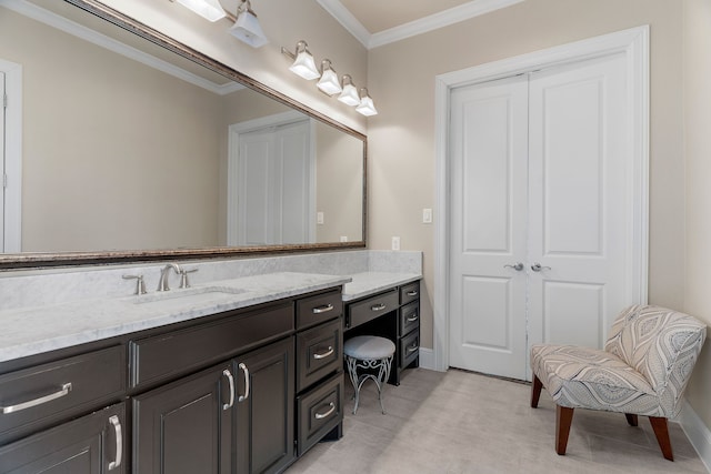 bathroom with baseboards, vanity, and crown molding