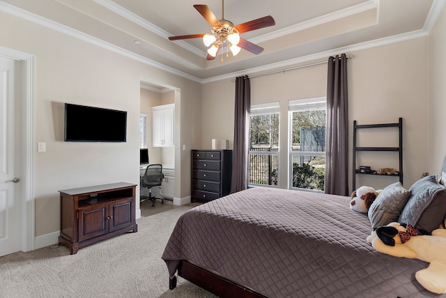 bedroom featuring a tray ceiling, light carpet, crown molding, and baseboards