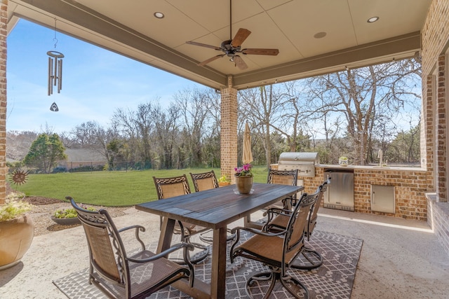 view of patio / terrace with outdoor dining space, area for grilling, ceiling fan, and an outdoor kitchen